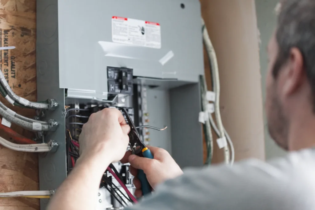 Electrician replacing the distribution board to upgrade a homes electrical panel.